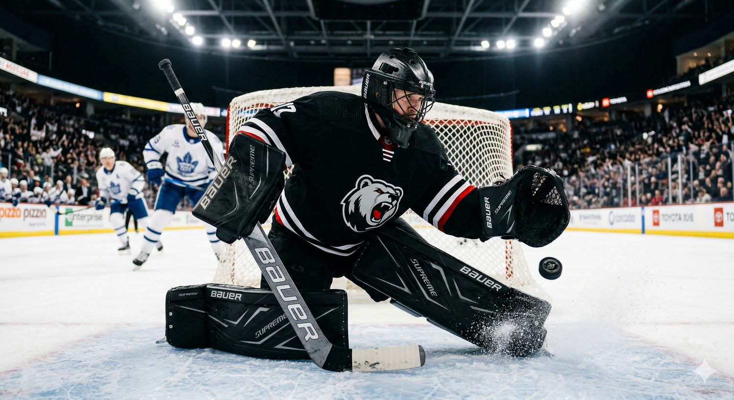 an ice hockey goalie making a save wearing black goalie gear