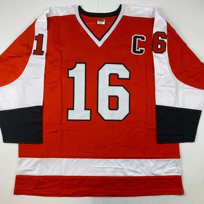 Autographed/Signed Reggie Leach, Bobby Clarke & Bill Barber Philadelphia Orange Hockey Jersey PSA/DNA COA